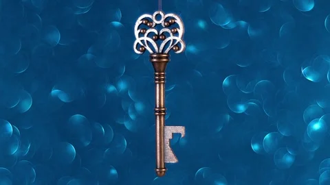 Beautiful decorative bronze key rotates on a blurred background. Closeup. Macro Stock Footage 297757706