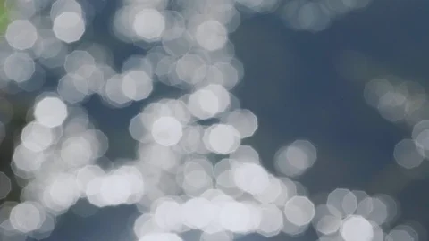 Beautiful deep blue water surface shines bokeh slow motion Stock Footage 118850867