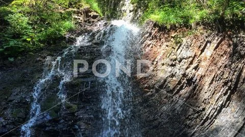 Beautiful deep forest waterfall. Stock Photos