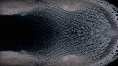 A Beautiful, delicate milky pattern, over black, mesmerizes - source is a c.. Stock Footage 257949068