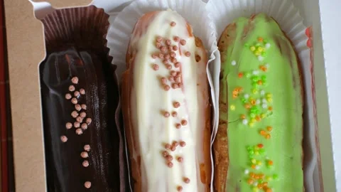 Beautiful delicious eclair cakes in box in close up Video stock 281050676