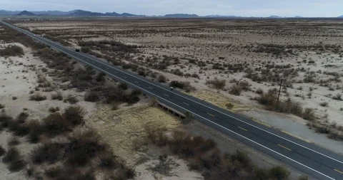 Beautiful desolate ladscape surrounds cyclist cycling along drone aerial 4K Stock Footage 111310627