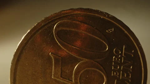 Beautiful detailed macro of a 50 cent Euro coin standing against a golden Stock Footage 320621213