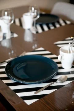 Beautiful dining table setup with blue plate Stock Photos