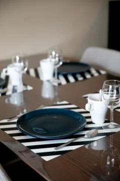 Beautiful dining table setup with blue plate Stock Photos
