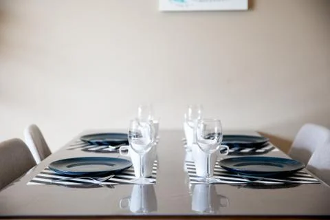 Beautiful dining table setup with blue plate Stock Photos