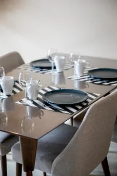 Beautiful dining table setup with blue plate Stock Photos