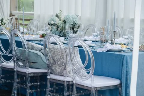 Beautiful dinner setting, long table set for an event on a terrace. Stock Photos