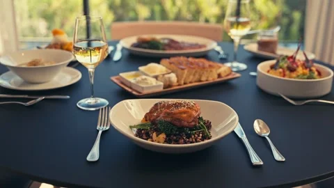 Beautiful Dinner Setup at a Restaurant with beets chicken bread wine cinematic Stock Footage 280514653