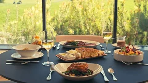 Beautiful Dinner Setup at a Restaurant with beets chicken bread wine cinematic 库存影片 280514664