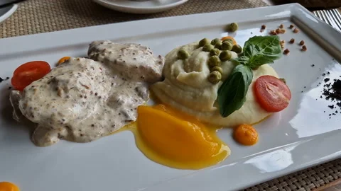 A beautiful dish from the restaurant. Mashed potatoes with vegetables and meat. Stock Footage 207675020