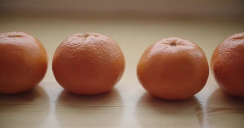 Beautiful display of fresh oranges resting on wooden surface Stock Footage 299715977