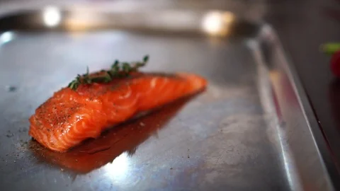 Beautiful display of raw fish meat salmon fillet steak next to fresh healthy Stock Footage 106982867