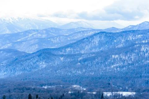 Beautiful distant winter mountains landscape with clouds Stock Photos