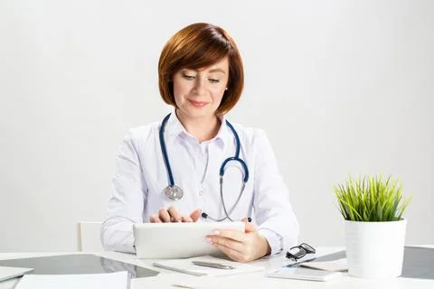 Beautiful doctor using tablet computer Stock Photos