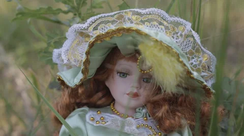 The beautiful doll in grass Stock Footage 32791680