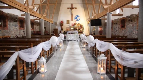 Beautiful dolly tracking shot down the aisle of an empty church decorated for Stock Footage 89739758