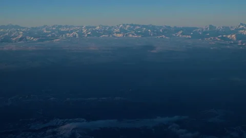 Beautiful dramatic aerial view of landscape, snow-capped blue mountain peaks Stock Footage 245909626