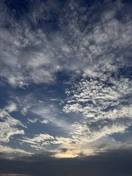 Beautiful Dramatic Blue Sky with White Fluffy Clouds at Sunset Stock Photos