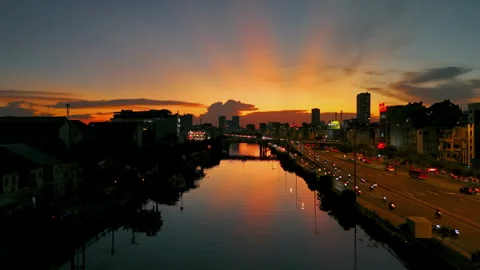 Beautiful Dramatic Golden Sunset Cast Over Urban Riverside Stock Footage 301301834