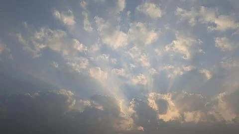 Beautiful dramatic low angle view captures bright sun rays breaking through.. Stock Photos