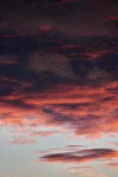Beautiful dramatic sky with dark and bright clouds at sunset, summer landscap Stock Photos