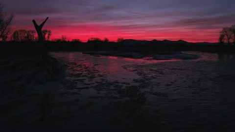 Beautiful dramatic sky over the  flowing river during winter 動画素材 91983745