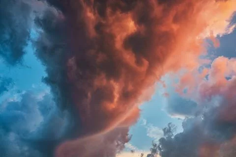 Beautiful dramatic storm clouds in the sunset sky Stock Photos