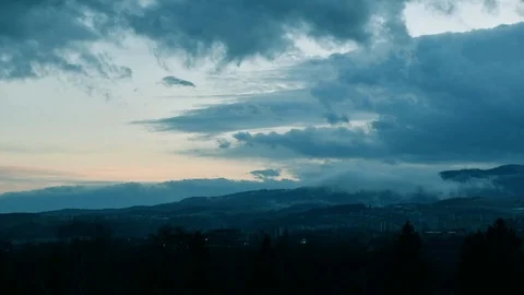Beautiful dramatic sunset evening with fast moving clouds over town Stock Footage 104305722