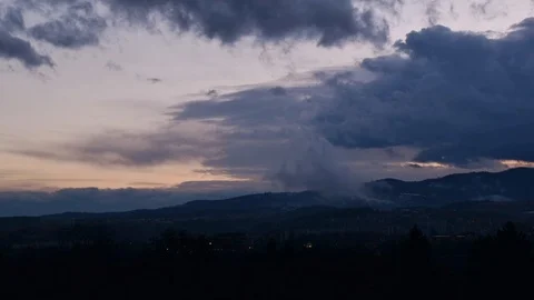 Beautiful dramatic sunset evening with fast moving clouds over town Stock Footage 104432893