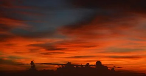 Beautiful dramatic sunset with  orange sky and awesome golden reflection. Stock Photos