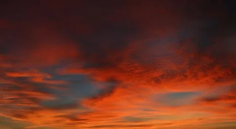Beautiful dramatic sunset with  orange sky and awesome golden reflection. Stock Photos