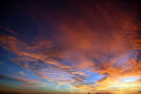 Beautiful dramatic sunset with  orange sky and awesome golden reflection. Stock Photos