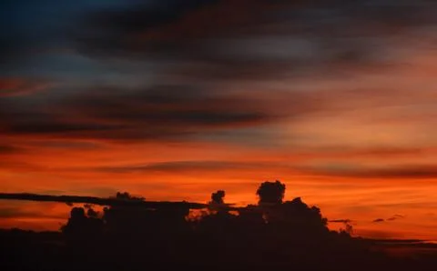 Beautiful dramatic sunset with  orange sky and awesome golden reflection. Stock Photos