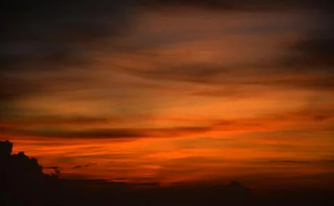 Beautiful dramatic sunset with  orange sky and awesome golden reflection. Stock Photos