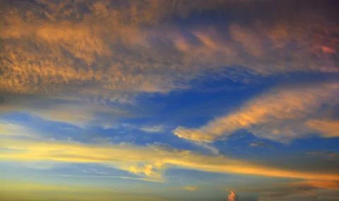 Beautiful dramatic sunset with  orange sky and awesome golden reflection. Stock Photos