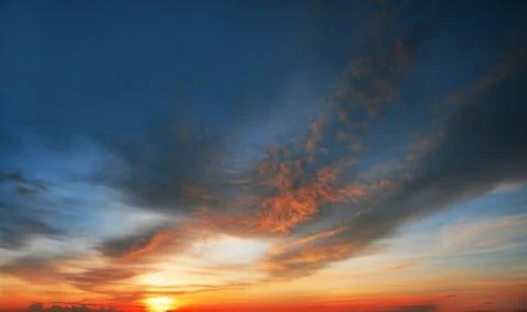 Beautiful dramatic sunset with  orange sky and awesome golden reflection. Stock Photos