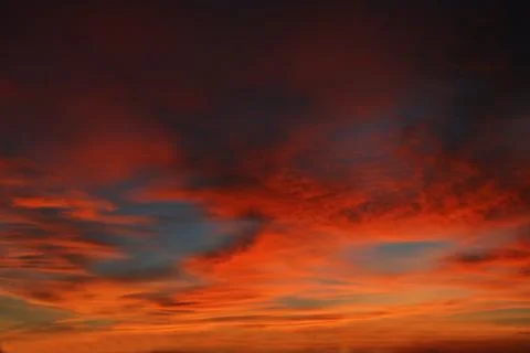 Beautiful dramatic sunset with  orange sky and awesome golden reflection. Stock Photos