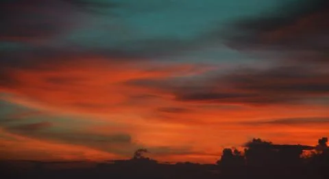 Beautiful dramatic sunset with  orange sky and awesome golden reflection. Stock Photos