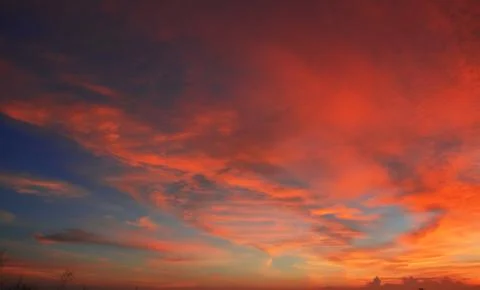 Beautiful dramatic sunset with  orange sky and awesome golden reflection. Stock Photos