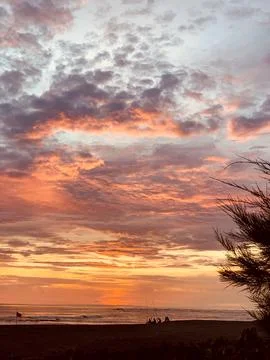Beautiful dramatic sunset over the sea. Fisherman silhouettes Stock Photos