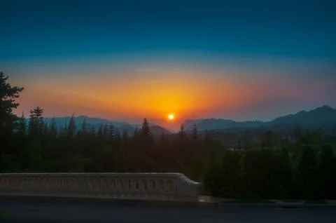 Beautiful dramatic sunset sky over the mountains. the rays of the evening sun Stock Photos