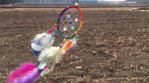Beautiful dreamcatcher is blowing in the wind on a desolate land. Stock Footage 84650493
