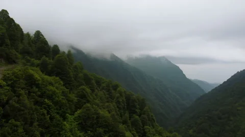 Beautiful drone flying above the path to cold blue peaks in Caucasian mountains Stock Footage 229835291
