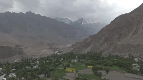 Beautiful Drone Pull Out Revealing Scenic Ladakh Village with Snow Peaks with Stock Footage 335747688