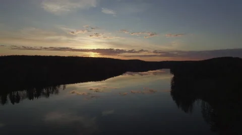 Beautiful drone shot with sunset and lake with reflections - Finland Video stock 64338366