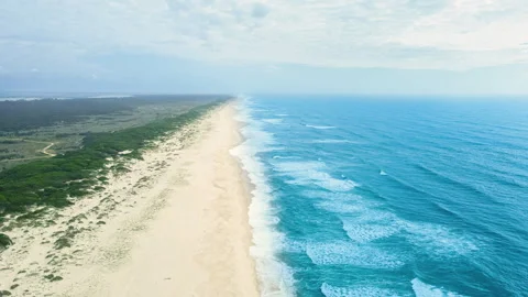 Beautiful drone view of the Atlantic ocean, waves, sky, and empty sandy beach Stock Footage 241116670