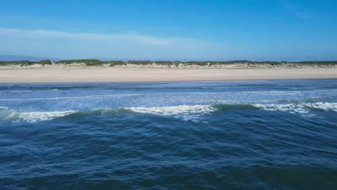 Beautiful drone view of the Atlantic ocean, high waves, blye sky, and empty Stock Footage 250355668