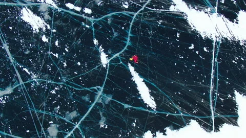 Beautiful drone view man ice skating frozen lake surface. Winter sport outdoor. Stock Footage 344764448
