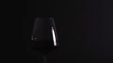 A beautiful drop flows down a glass with a fin on a black background, isolated Stock Footage 125024787
